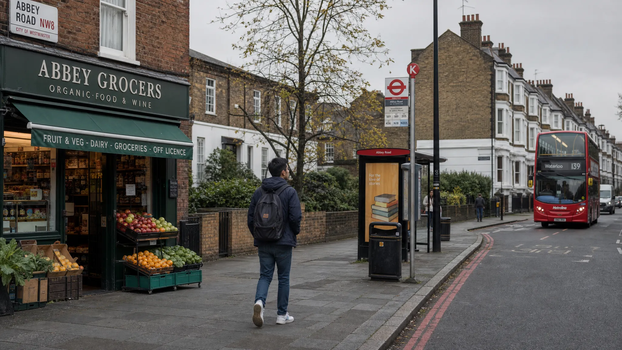 An international student walking along a quiet London street with a backpack, passing brick houses, a corner grocery shop, and a bus stop on a cloudy afternoon.